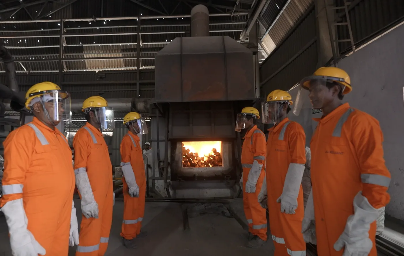 Casting crew observing the melting furnace