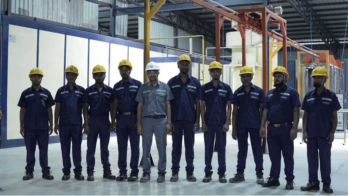 Powder coating team in front of the automated coating booths