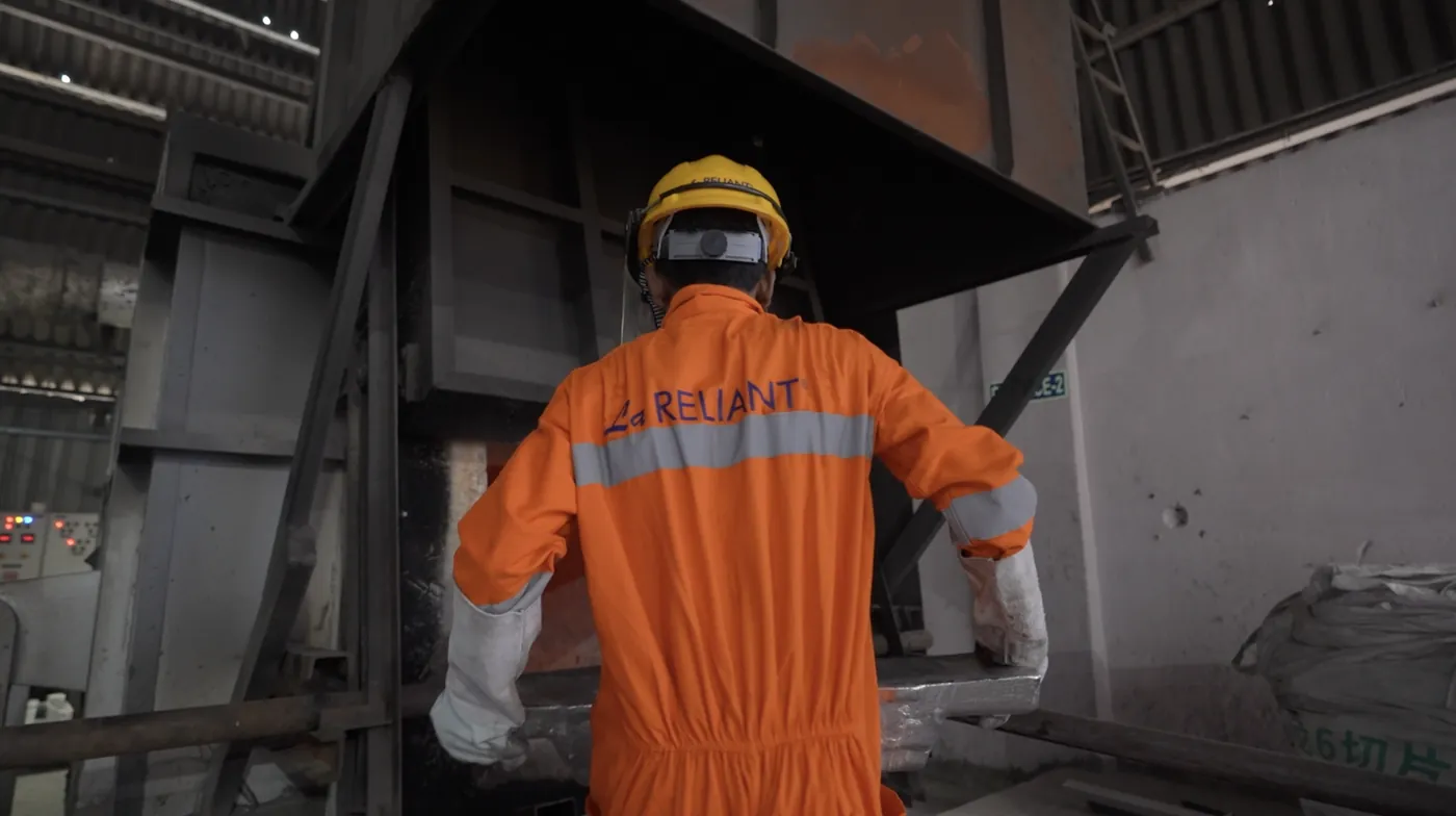 Operator at the charging door of the melting furnace