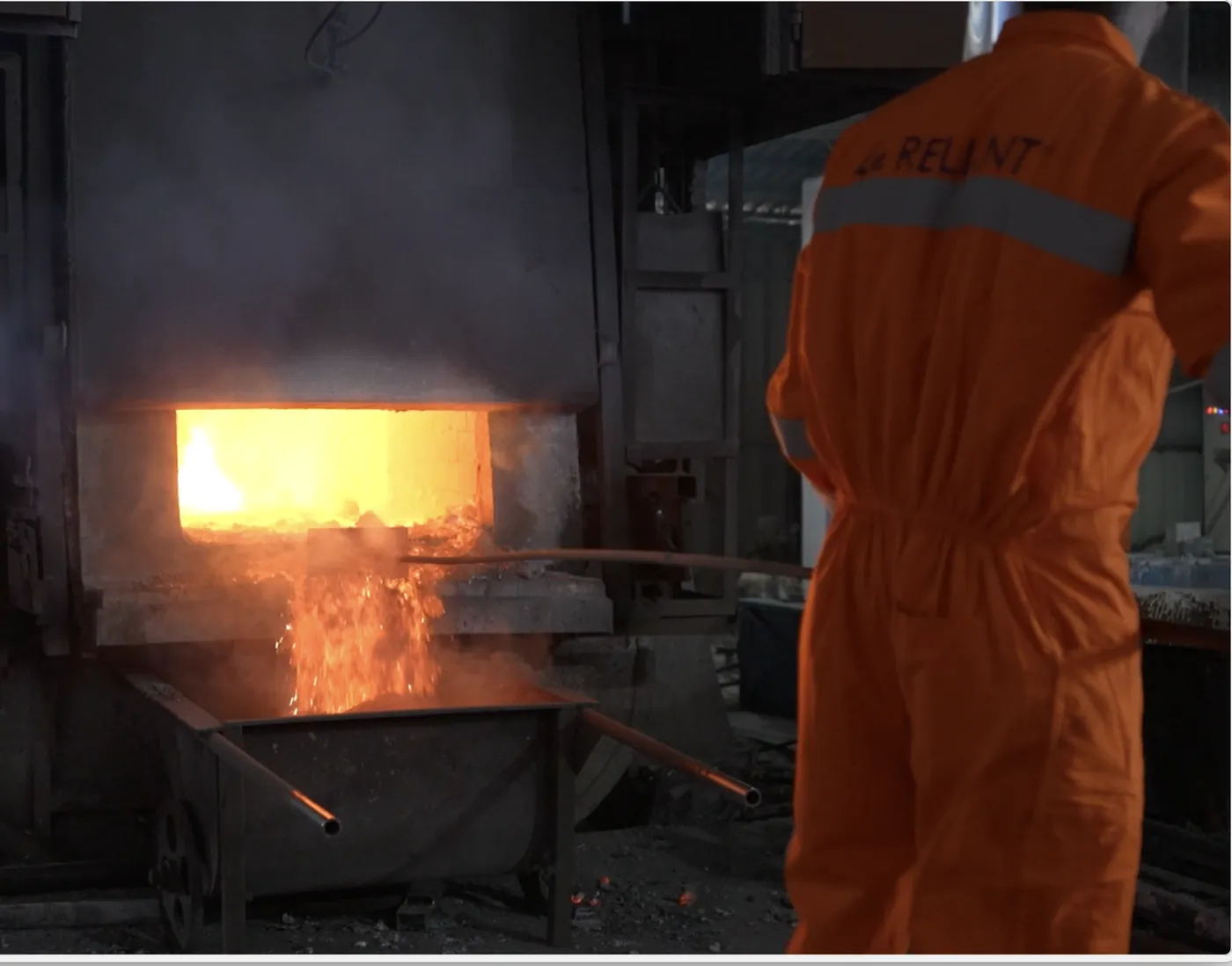 Operator charging the melting furnace