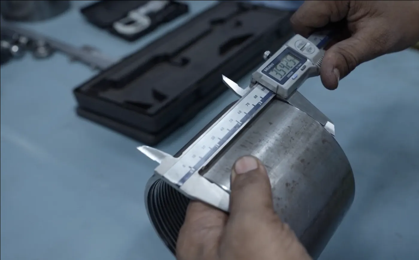 Quality inspector measuring an extruded profile with a Vernier calliper