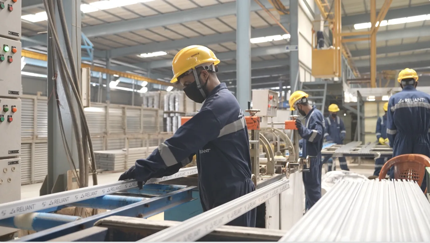 Operator handling sections in La Reliant protective tape on the packaging line