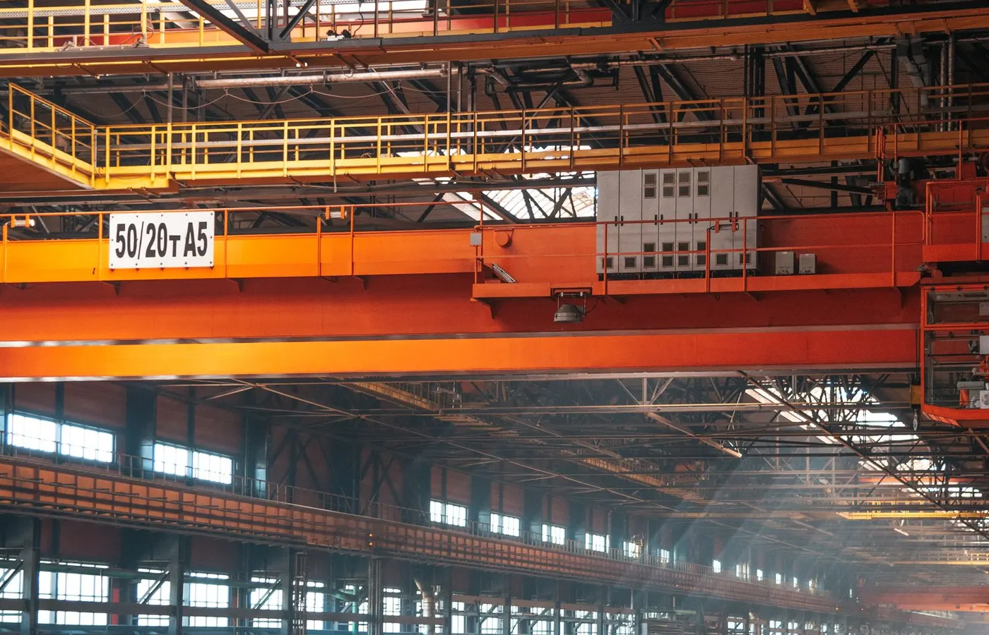 Overhead travelling cranes above an industrial plant floor