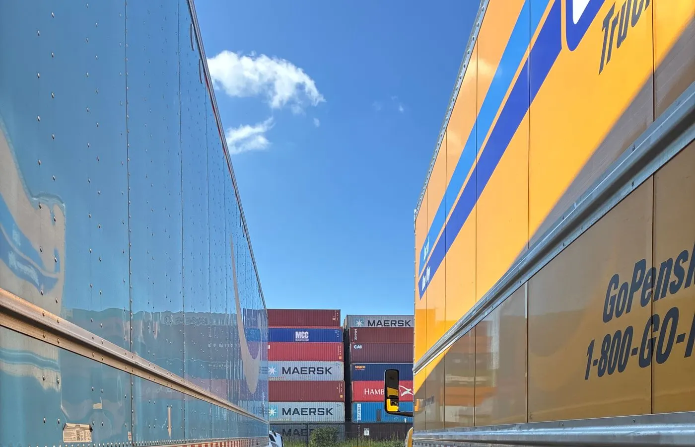 Aluminium-bodied freight trailers at a container yard